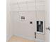 The functional laundry room has wire shelves and utility connections at 1555 Diplomat Dr, Cumming, GA 30041