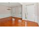 Bright living room with hardwood floors, chandelier, and white wainscoting welcomes you home at 1555 Diplomat Dr, Cumming, GA 30041