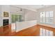 Bright living room with a fireplace, hardwood floors, and sliding doors to the patio offers a warm ambiance at 1555 Diplomat Dr, Cumming, GA 30041