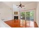 Living room with hardwood floors, fireplace and access to the patio offers an open and airy feel at 1555 Diplomat Dr, Cumming, GA 30041