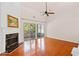 Spacious living room with hardwood floors, a fireplace, and natural light coming from sliding patio doors at 1555 Diplomat Dr, Cumming, GA 30041