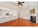 Open living room with a fireplace, hardwood floors, and kitchen views provides room to entertain at 1555 Diplomat Dr, Cumming, GA 30041
