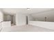 A cozy loft featuring neutral carpeting, lighting fixtures, and a half wall at 1555 Diplomat Dr, Cumming, GA 30041