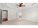 Large bedroom with tray ceiling and doorways to a closet and the bathroom at 1555 Diplomat Dr, Cumming, GA 30041