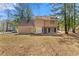 Backyard of a two-story house with mature trees and ample space for outdoor activities at 7438 Chilton Ln, Riverdale, GA 30296