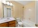 A well-lit bathroom features a bathtub, shower, toilet, and vanity with sink at 7438 Chilton Ln, Riverdale, GA 30296