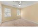 A serene bedroom filled with natural light from windows and complete with a ceiling fan at 7438 Chilton Ln, Riverdale, GA 30296