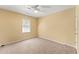 Bedroom featuring neutral walls, large window providing natural light, and a ceiling fan for comfort at 7438 Chilton Ln, Riverdale, GA 30296