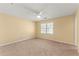 Bedroom featuring neutral walls, ceiling fan and a large window providing natural light at 7438 Chilton Ln, Riverdale, GA 30296