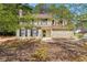Charming two-story home featuring a well-maintained lawn and inviting front entrance at 7438 Chilton Ln, Riverdale, GA 30296