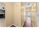 Hallway view of a living room fireplace and a sun room with large windows at 7438 Chilton Ln, Riverdale, GA 30296