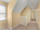Upstairs hallway showing neutral paint, and carpet flooring, offering a versatile and inviting space at 7438 Chilton Ln, Riverdale, GA 30296