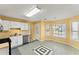 Cozy kitchen featuring white cabinetry, stainless steel appliances, and a sunlit dining area at 7438 Chilton Ln, Riverdale, GA 30296