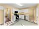 Kitchen featuring white cabinetry and modern stainless steel appliances at 7438 Chilton Ln, Riverdale, GA 30296