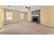 Open living room featuring a stone fireplace and large windows at 7438 Chilton Ln, Riverdale, GA 30296