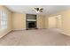 Spacious living room with a stone fireplace and neutral carpet at 7438 Chilton Ln, Riverdale, GA 30296