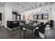Modern dining area with black table and white chairs next to a kitchen island and stainless steel appliances at 878 Peachtree Ne St # 711, Atlanta, GA 30309