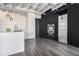 Modern kitchen with stainless steel appliances, black cabinets, and wooden floors at 878 Peachtree Ne St # 711, Atlanta, GA 30309