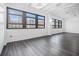 Bright living room featuring large windows with city views and wood flooring at 878 Peachtree Ne St # 711, Atlanta, GA 30309