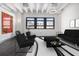 Modern living room featuring black furnishings, large windows, and stylish decor at 878 Peachtree Ne St # 711, Atlanta, GA 30309