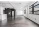 Spacious living room with large windows, wood floors, and a modern kitchen at 878 Peachtree Ne St # 711, Atlanta, GA 30309