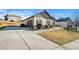 Exterior angle showcasing a driveway leading to a two-car garage and a beautifully landscaped front yard at 20 Gentle Spring Ln, Covington, GA 30016