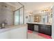 Modern bathroom featuring a glass-enclosed shower, double vanity with dark cabinets, and decorative light fixtures at 4050 Ironwood Dr, Atlanta, GA 30349