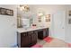 Bathroom with a double vanity with dark cabinets, a large mirror, decorative light fixtures, and a tiled floor at 4050 Ironwood Dr, Atlanta, GA 30349