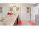 Bathroom with a double vanity with a large mirror, decorative light fixtures, and tiled floors at 4050 Ironwood Dr, Atlanta, GA 30349