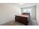 Neutral bedroom with plush carpet, a wood sleigh bed frame, and plenty of natural light at 4050 Ironwood Dr, Atlanta, GA 30349