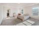 Bedroom with en-suite bathroom, featuring tray ceilings, carpet flooring and great natural light at 4050 Ironwood Dr, Atlanta, GA 30349