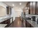 Bright kitchen boasts stainless appliances, granite counters, and dark wood floors and cabinets at 4050 Ironwood Dr, Atlanta, GA 30349