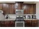 A functional kitchen featuring stainless steel appliances and dark wood cabinets at 4050 Ironwood Dr, Atlanta, GA 30349