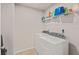 Laundry room featuring a modern washer and dryer with convenient shelf storage space at 4050 Ironwood Dr, Atlanta, GA 30349