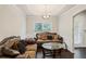 An elegant living room featuring couches and a table, illuminated by soft natural light at 4050 Ironwood Dr, Atlanta, GA 30349