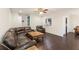 Open concept living room with hardwood floors, a leather sofa, and a seamless flow to other areas at 4050 Ironwood Dr, Atlanta, GA 30349