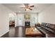 Comfortable living room featuring a fireplace, dark wood floors, and plenty of natural light at 4050 Ironwood Dr, Atlanta, GA 30349