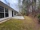 Backyard featuring a patio, fire pit area, and natural surroundings, offering a peaceful outdoor setting at 950 Spring Ives Dr, Lawrenceville, GA 30043