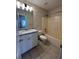 Bathroom featuring a vanity with granite countertops and a tub at 950 Spring Ives Dr, Lawrenceville, GA 30043
