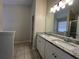Bathroom featuring double sink vanity with granite countertop, tile floors, and shower with glass door at 950 Spring Ives Dr, Lawrenceville, GA 30043