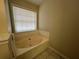Bathroom featuring a sunken bathtub, enhancing relaxation and a serene bathing experience at 950 Spring Ives Dr, Lawrenceville, GA 30043