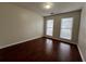Bedroom with hardwood floors and two windows at 950 Spring Ives Dr, Lawrenceville, GA 30043