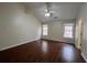 Bright bedroom with vaulted ceiling, a ceiling fan, hardwood floors, and natural light from two windows at 950 Spring Ives Dr, Lawrenceville, GA 30043