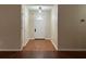 View of the entryway featuring hardwood floors, white trim, and a modern lighting fixture at 950 Spring Ives Dr, Lawrenceville, GA 30043