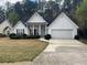 Charming home featuring a landscaped front yard, a two-car garage, and a columned front porch at 950 Spring Ives Dr, Lawrenceville, GA 30043