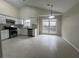 Modern kitchen featuring white cabinets, stainless steel appliances, and tiled floors at 950 Spring Ives Dr, Lawrenceville, GA 30043