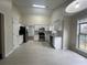 Bright kitchen with stainless steel appliances, white cabinetry, and a window overlooking the yard at 950 Spring Ives Dr, Lawrenceville, GA 30043