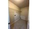 Neutral laundry room with practical shelving and tile flooring, perfect for efficient chore management at 950 Spring Ives Dr, Lawrenceville, GA 30043