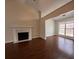 Cozy living room featuring hardwood floors, a fireplace, and large windows at 950 Spring Ives Dr, Lawrenceville, GA 30042