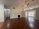 Open-concept living room with fireplace and hardwood floors connecting to other rooms at 950 Spring Ives Dr, Lawrenceville, GA 30043